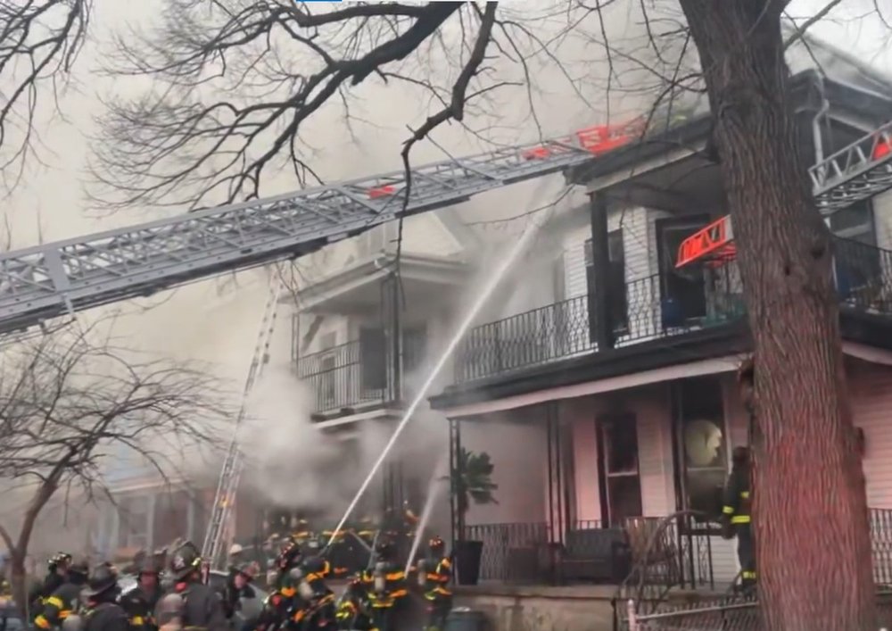 Firefighters respond to a four-alarm fire at 413 East 3rd St. in Kensington on March 22, 2024.