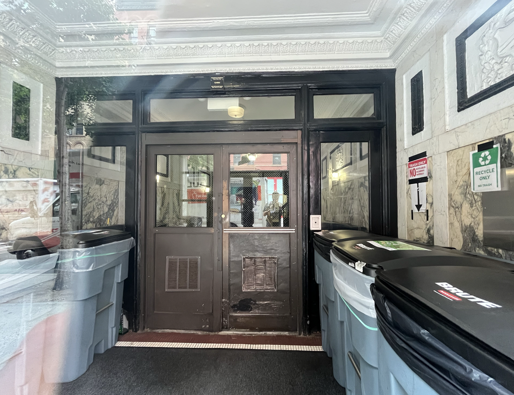 Some supers on East 10th Street are keeping trash bins inside their vestibules.
