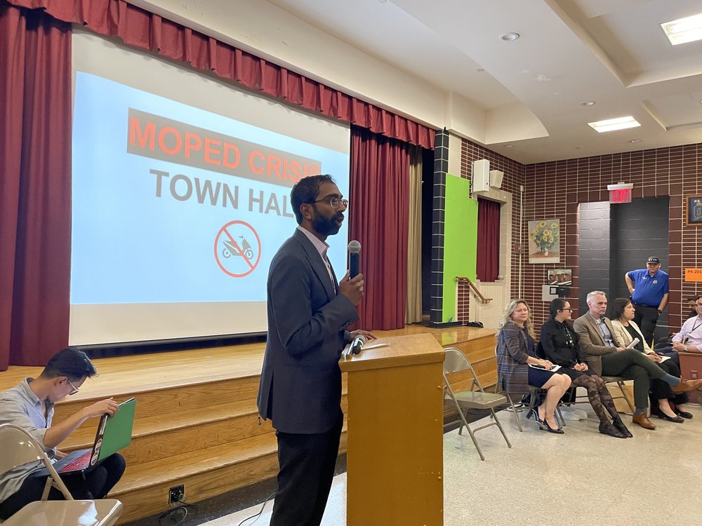 City councilmember Shekar Krishnan speaks at a town hall meeting in Queens about pedestrian safety and e-bikes.