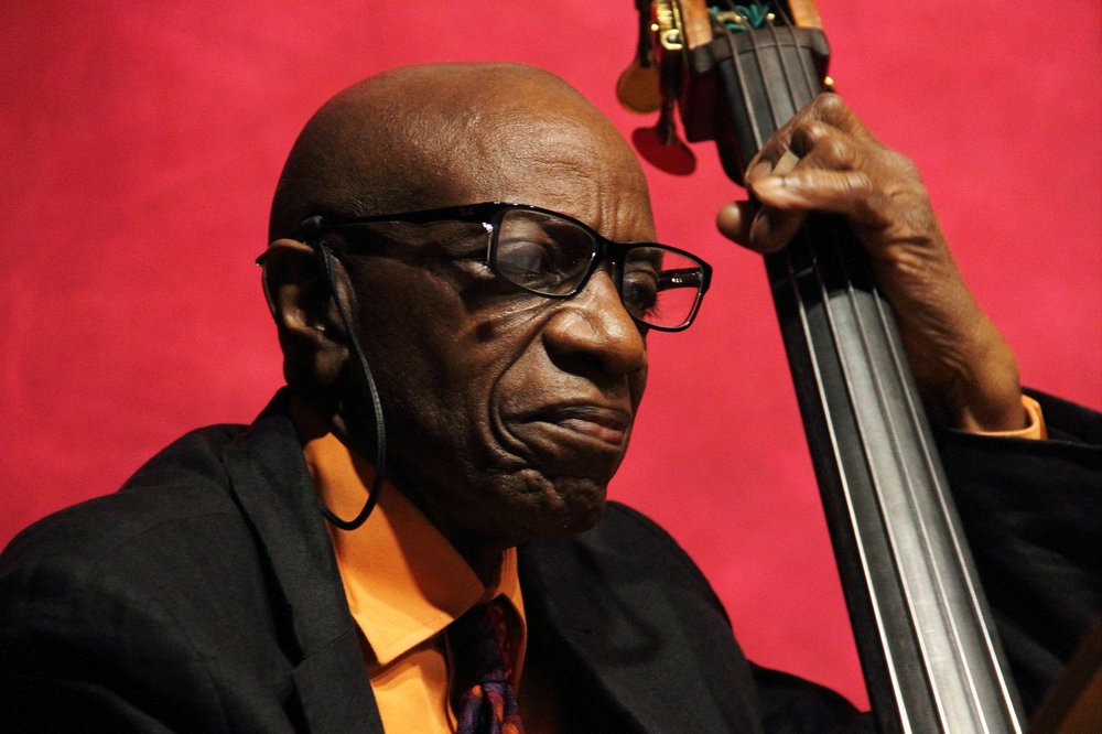 Close-up photo of a man playing a double bass