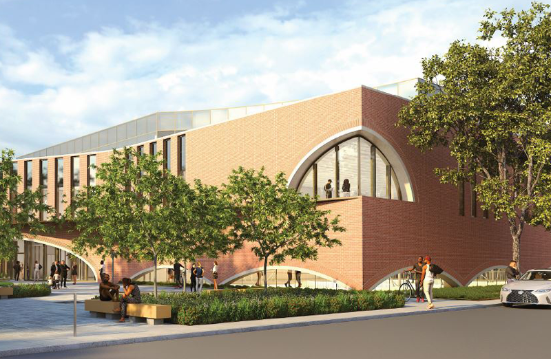 A rendering of the forthcoming Shirley Chisholm Recreation Center in East Flatbush, depicting a two-story brick building with an arched corner window and trees, grass, and benches in front.