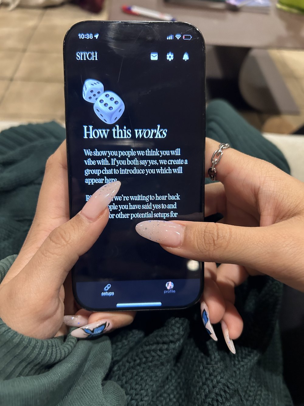 A woman displaying the dating app Sitch on her phone.