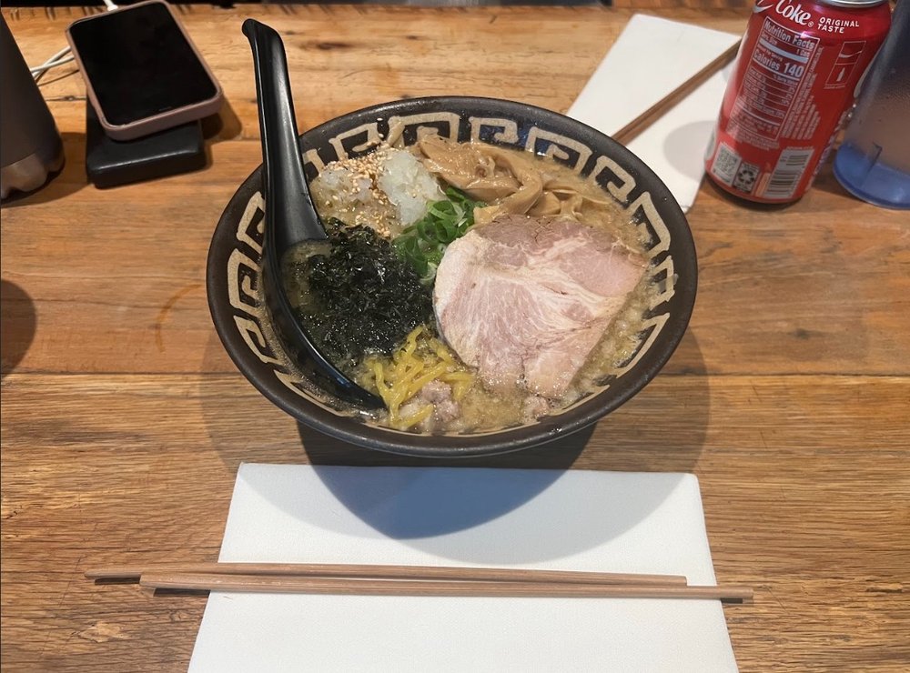 A bowl of ramen noodles with broth.