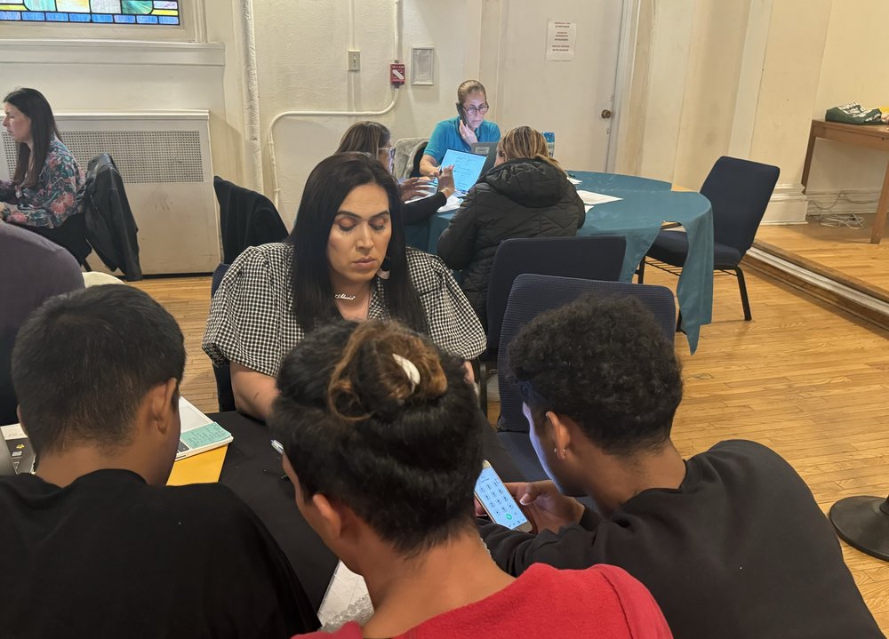 Volunteer Alexia Sol assisting migrants at Metro Baptist Church in Midtown.