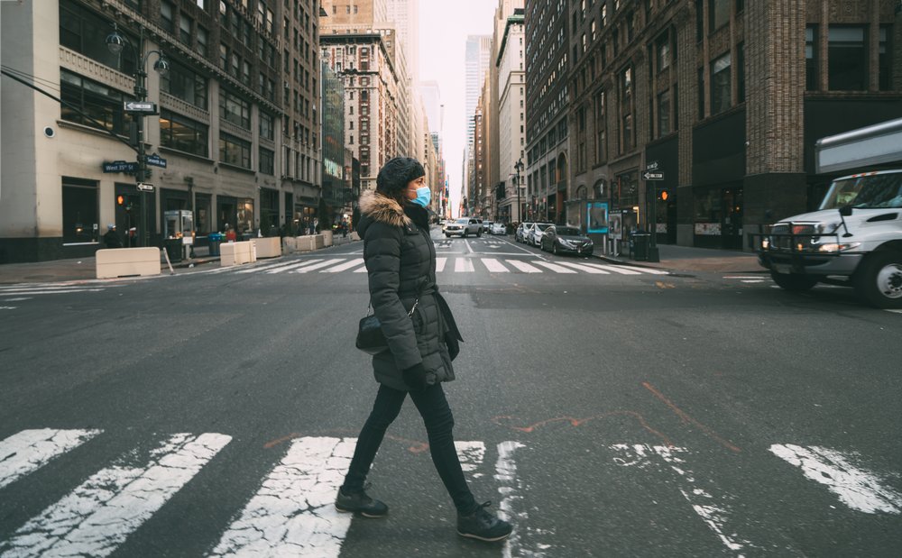 A photo of a woman walking alone in NYC.
