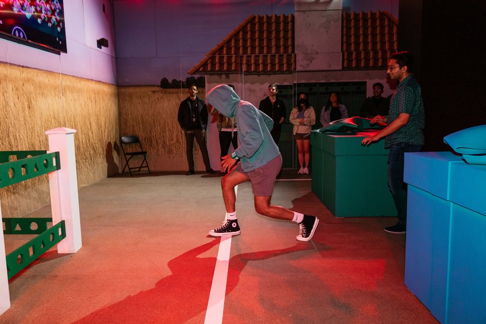 A person in a hoodie and shorts competes.