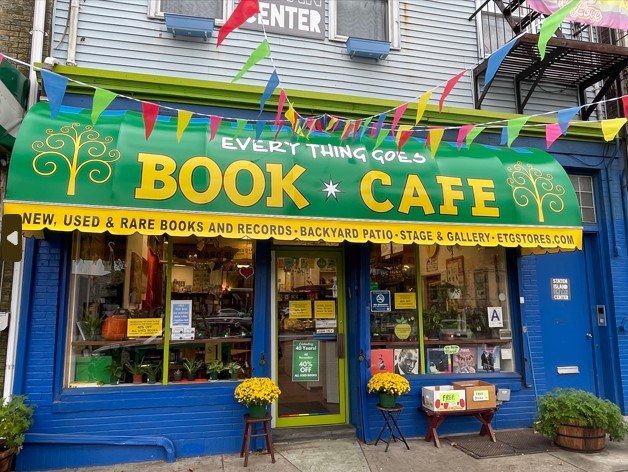 The exterior of a bookstore with a green awning.