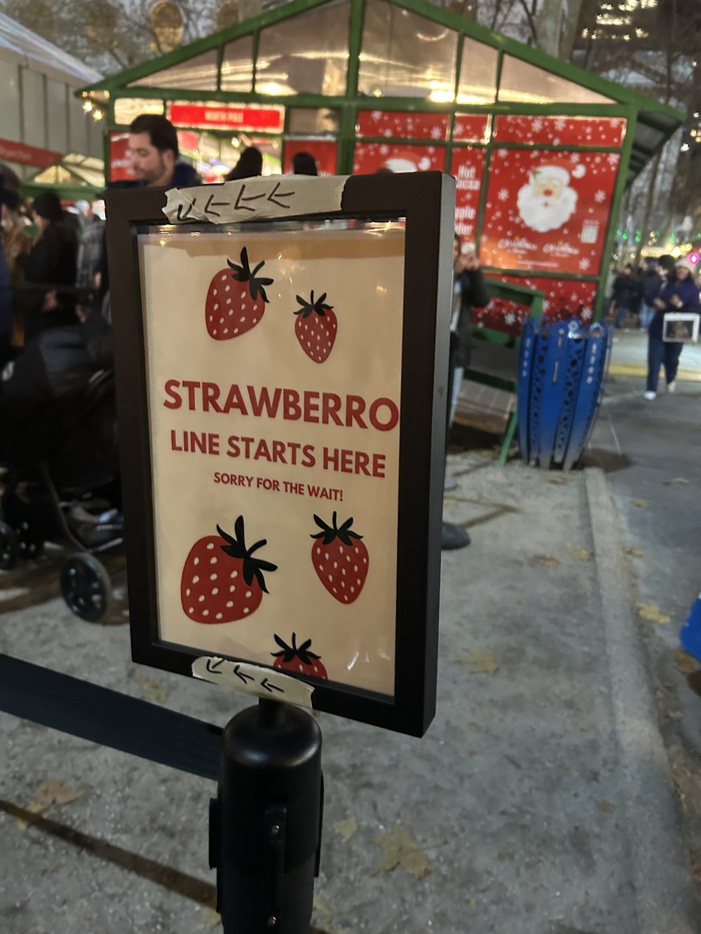 A sign for Strawbero that says "Line starts here"