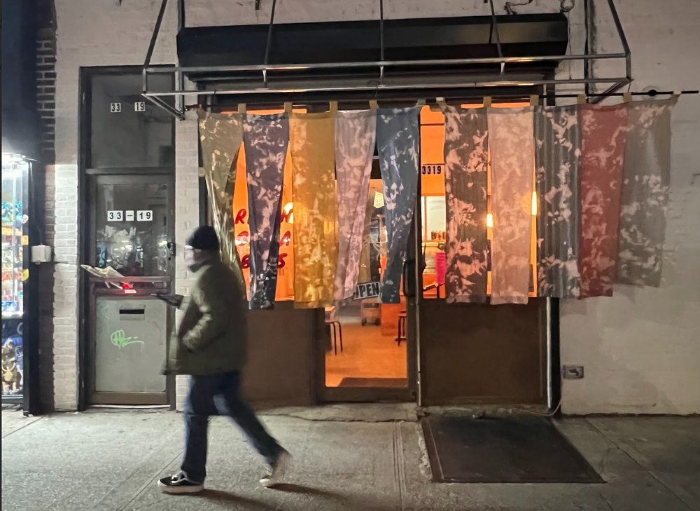 A person walks by the exterior of a restaurant.