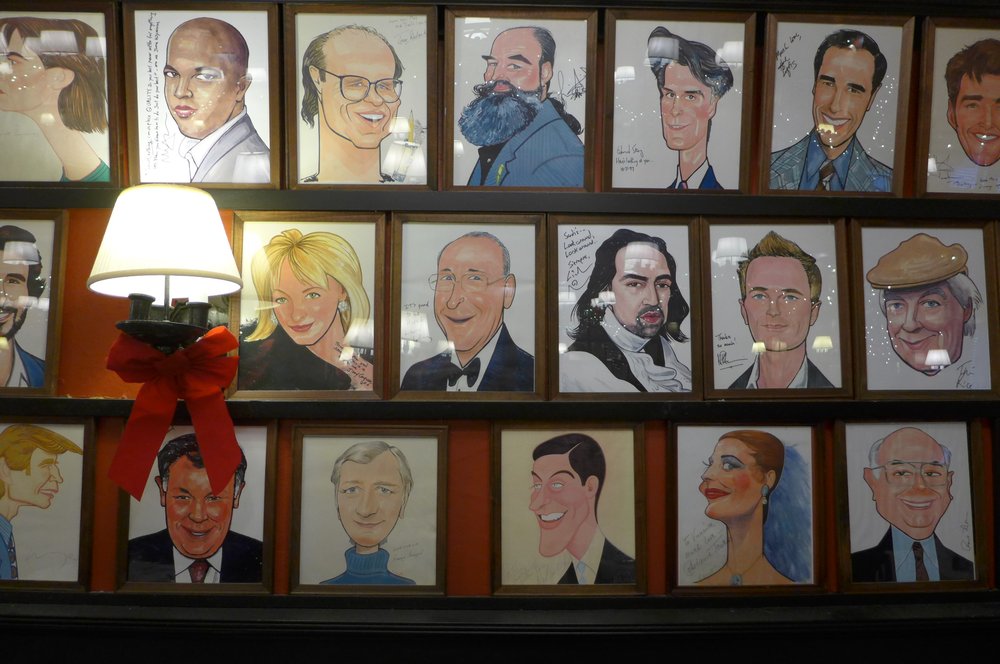 A wall lined with caricatures.