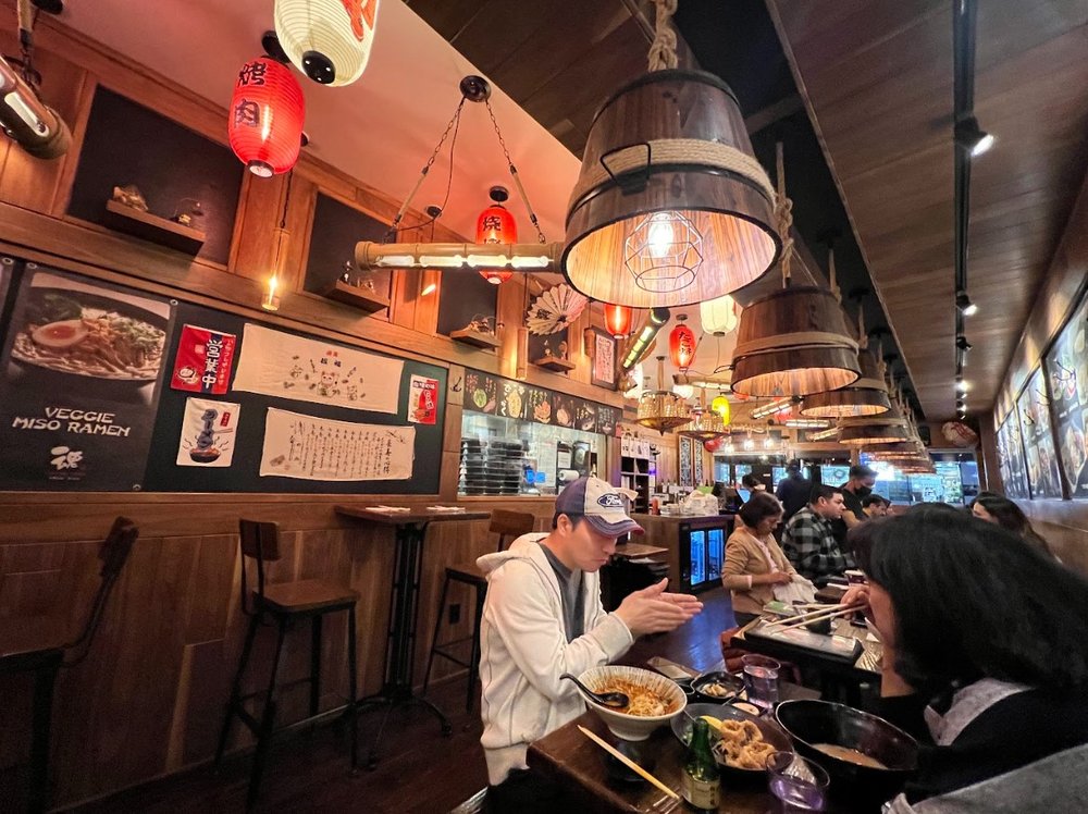 A man eats inside a restaurant.