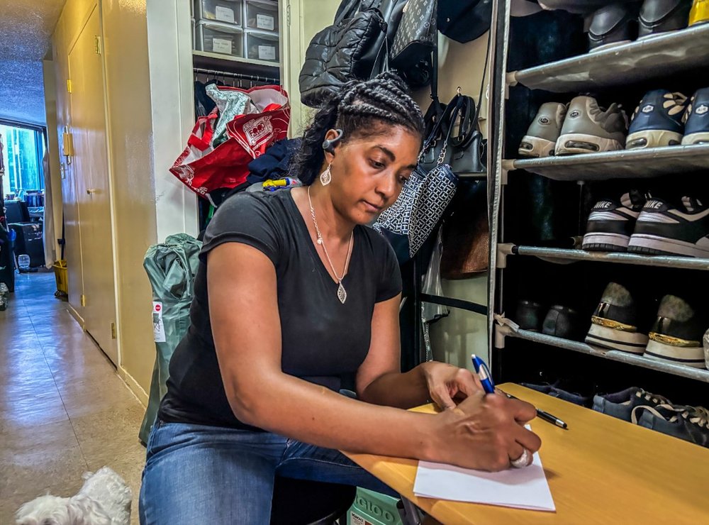 A woman signs a piece of paper.