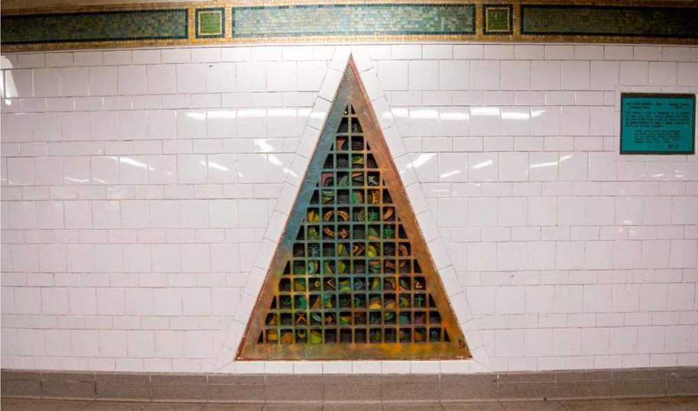 a series of bronze reliefs shaped like a triangle
