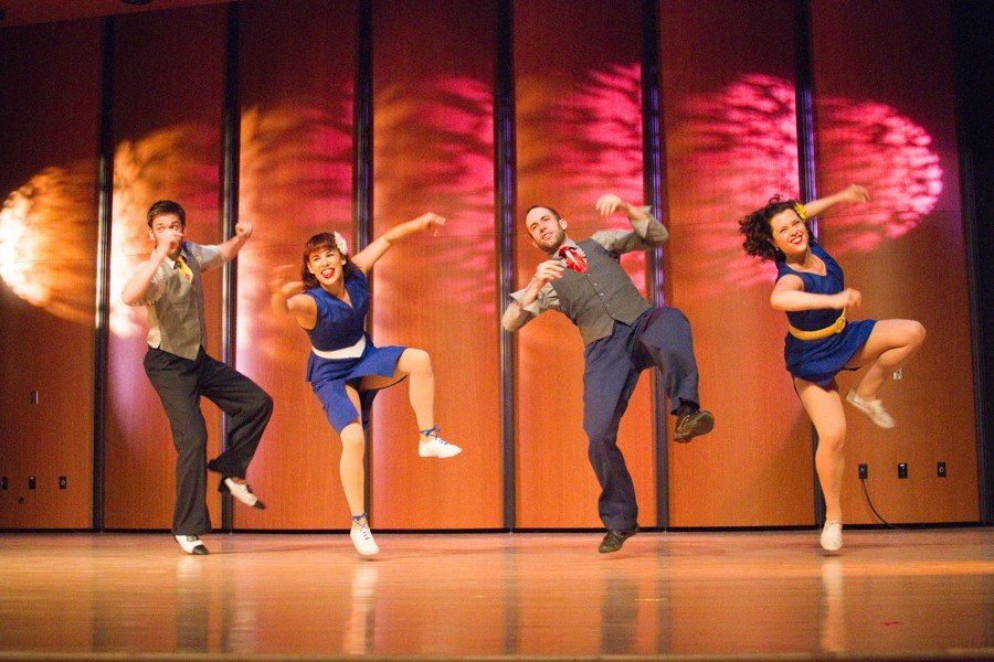 A group of people dancing on a stage