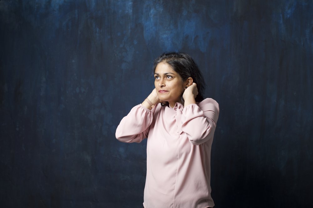 A woman in a pink shirt.