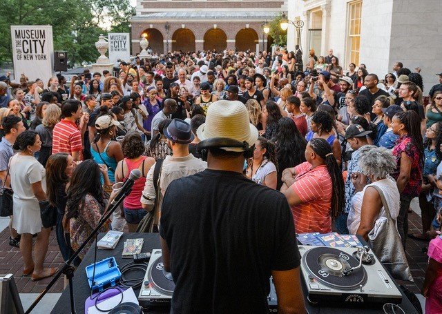 A DJ performs in front of a crowd.