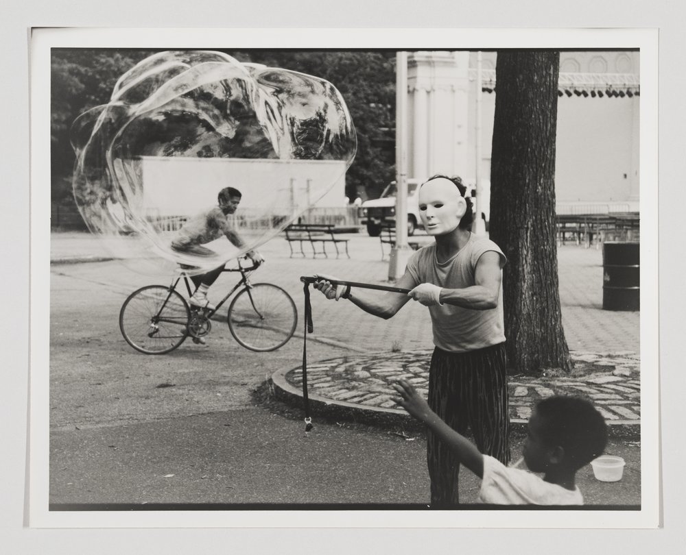 The photograph entitled "Man with Bubble, Central Park (Near Bandshell)" by artist Shawn Walker.