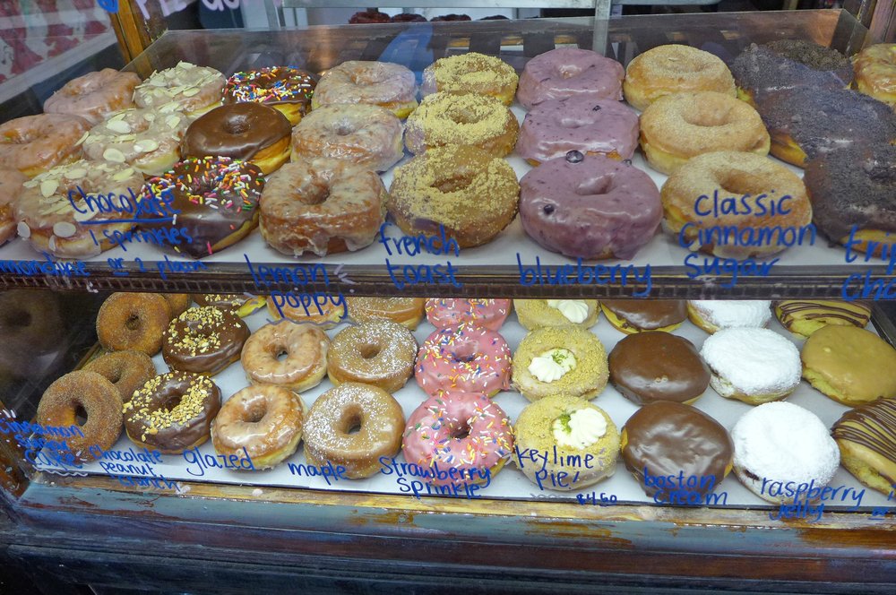 A dry case filled with colorful donuts.