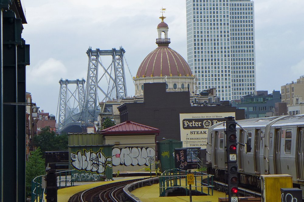 Train tracks leading to a metropolitan part of town.