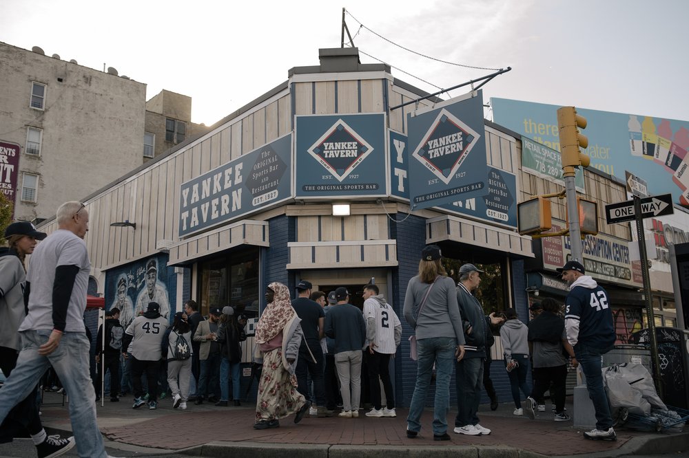 As fans make their way into Yankee Tavern at 72 East 161st Street, Yankee fans fill the sidewalks outside the Bronx bar before the start of the Yankees playoff game against the Houston Astros in New York City, New York, U.S., on Saturday, October 22, 2022.