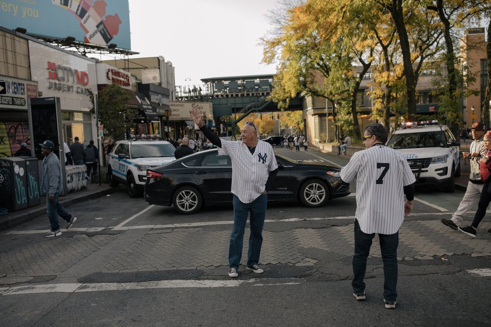 Don Bridges, center, and Lou DiLullo, right, march down Gerard Avenue towards River Avenue before the start of the Yankees playoff game against the Houston Astro.