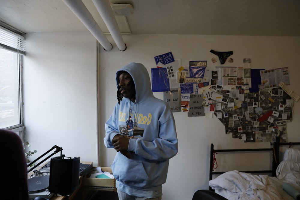 A student in a dorm room.