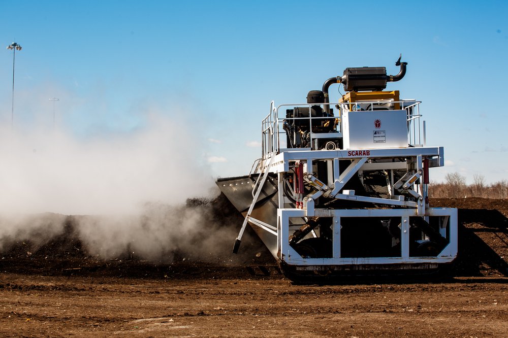 a537a11d9032517compostdsny-18-jpg.jpeg A DSNY machine aerates and tills windrows of reusable compost on Staten Island.</br>