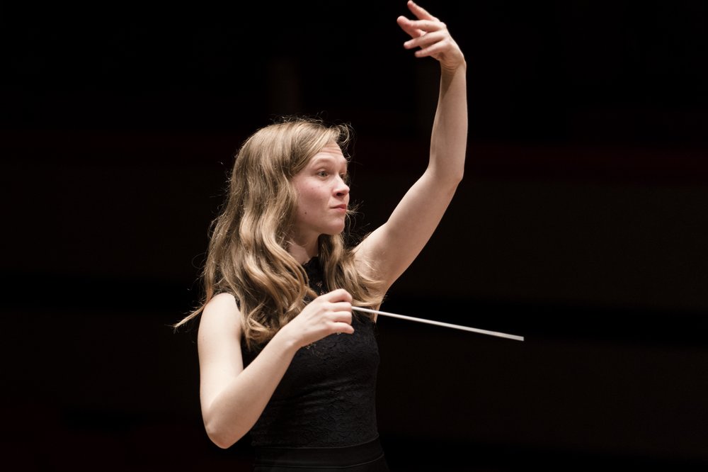 A woman conducting an orchestra