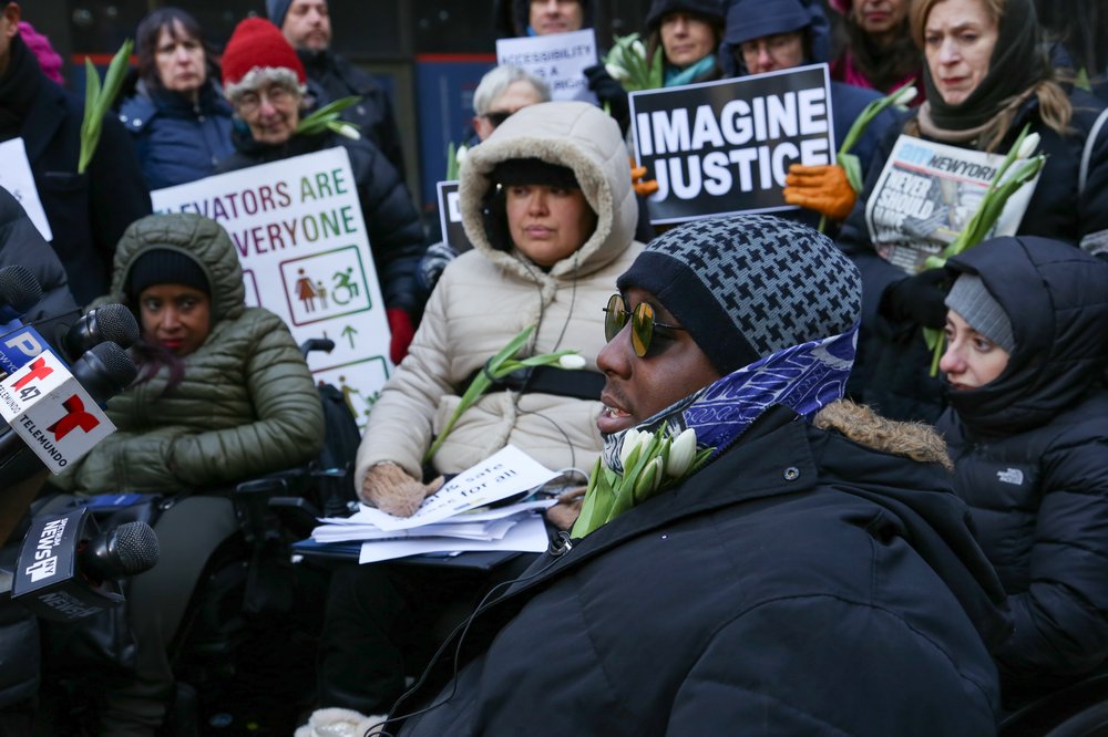 a7e5ae6e3img_9122-jpg.jpeg Dustin Jones (foreground) with other disability and transit rights advocates on January 30, 2019