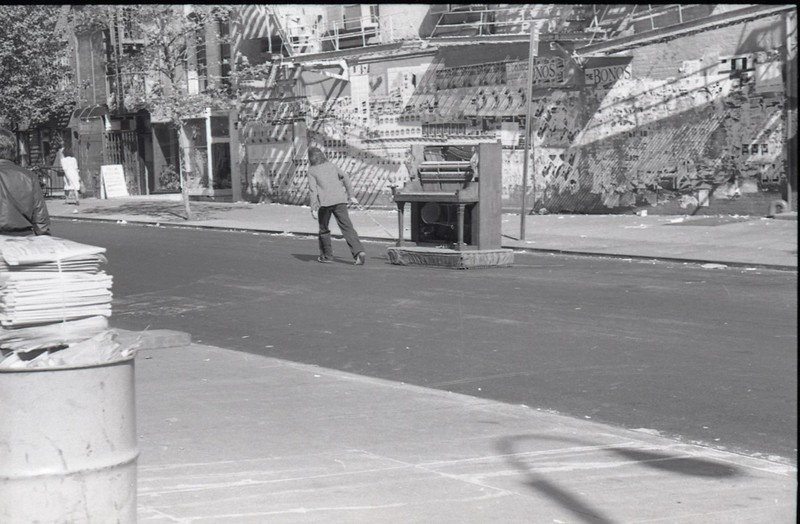 a89a209202bb8831445915c5fd2aa839724b51643-jpg.jpeg Man pulling piano down street, St. Marks Place just west of 2nd Avenue. 1980.<br/>