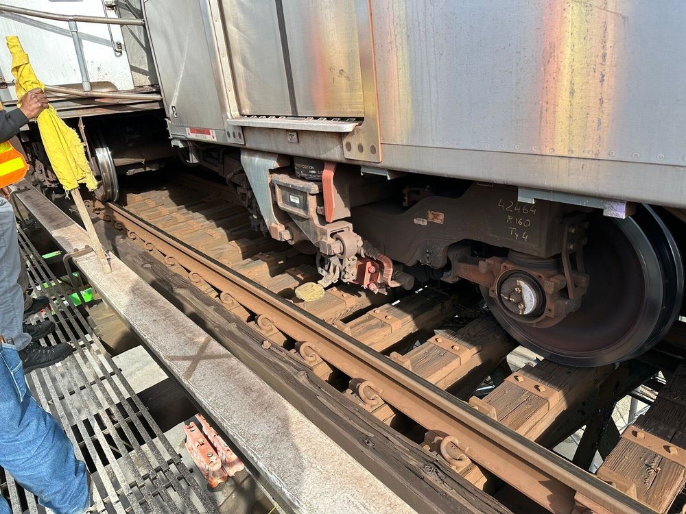 A photo of a derailed train in Brooklyn.