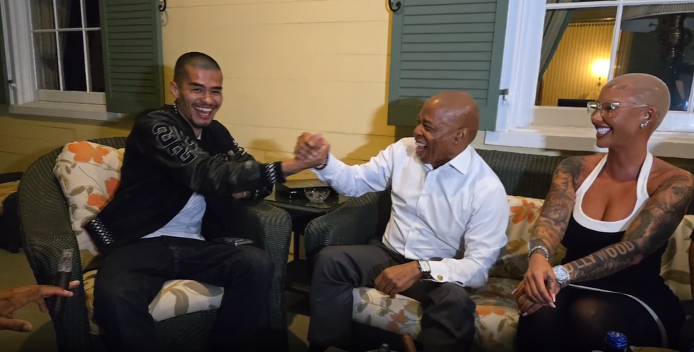 Mayor Eric Adams with Sneako, slapping hands and smiling.