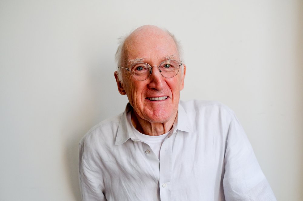 A smiling, older man with glasses.