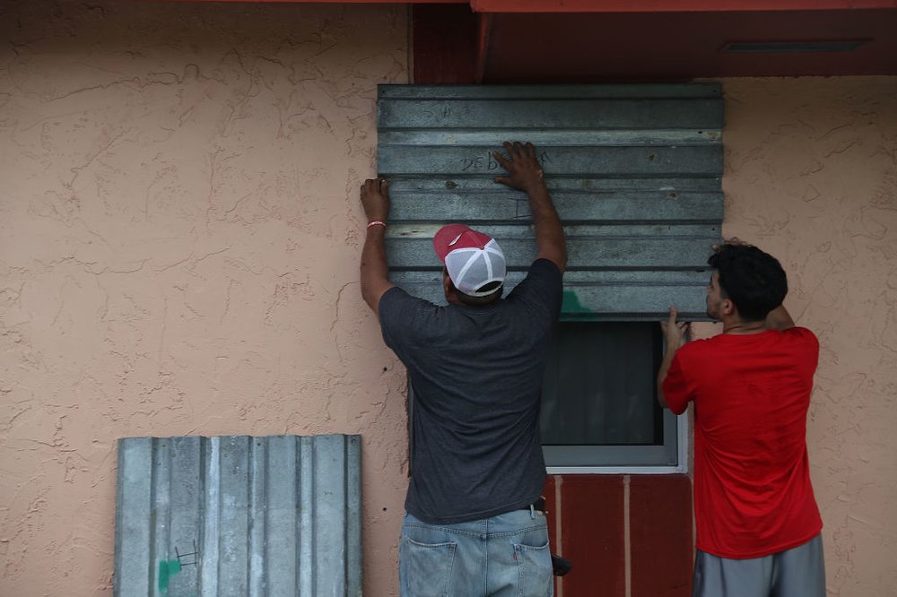 b5bd0ea5agettyimages-843069470-jpg.jpeg Jose Escobar and his son, Jose Escobar, jr. puts up shutters as they prepare for Hurricane Irma on September 5, 2017 in Homestead, Florida. (Getty Images)