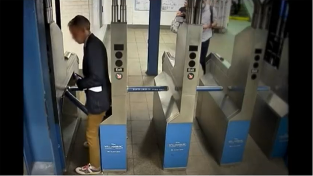 Surveillance footage of an rider evading the fare at a subway station.