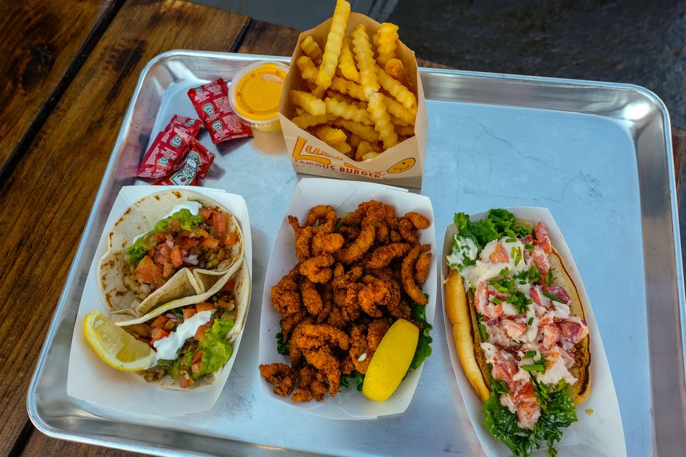 Cajun Shrimp Tacos ($12), Fried Clam Strips ($10), Angry Lobster Roll ($16), Crinkle Cut French Fries with cheese ($6)