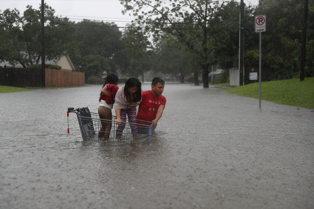 be9b4cd66gettyimages-839971182-jpg.jpeg A man helps children cross a road in Houston on August 27, 2017<br>