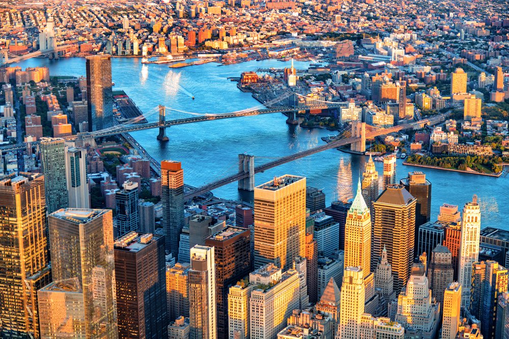 an aerial view of the Manhattan and Brooklyn Bridges