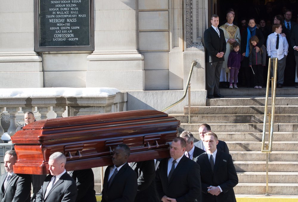 c0c633238.jpeg Hoffman's family looks on at the casket (Getty Images