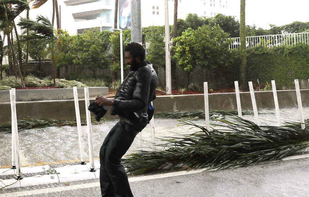c3b6fbad7gettyimages-845270564-jpg.jpeg A man walks through the street as high winds and rain from Hurricane Irma arrive on September 10, 2017 in Miami, Florida.