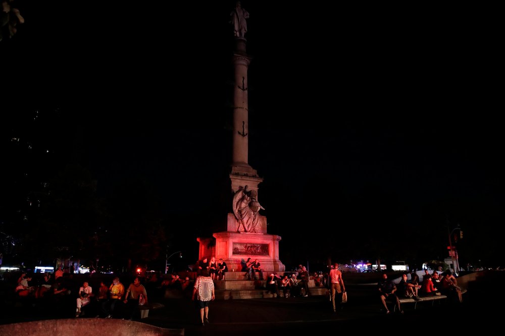 c3bfaa0d3shutterstock_10333913p-jpg.jpeg People sitting outside at Columbus Circle during the blackout (JASON SZENES/EPA-EFE/Shutterstock)
