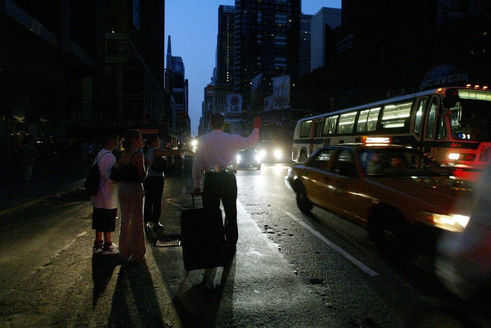 A man tries to hail a cab (Jason Szenes / EPA/Shutterstock)