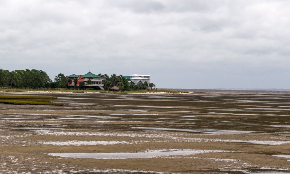 c5cbb397agettyimages-845428020-jpg.jpeg EASTPOINT, FL - SEPTEMBER 10: The counterclockwise circulation of Hurricane Irma pulls the Apalachicola Bay away from land September 10, 2017 near Eastpoint in the Florida panhandle. (Photo by Mark Wallheiser/Getty Images)