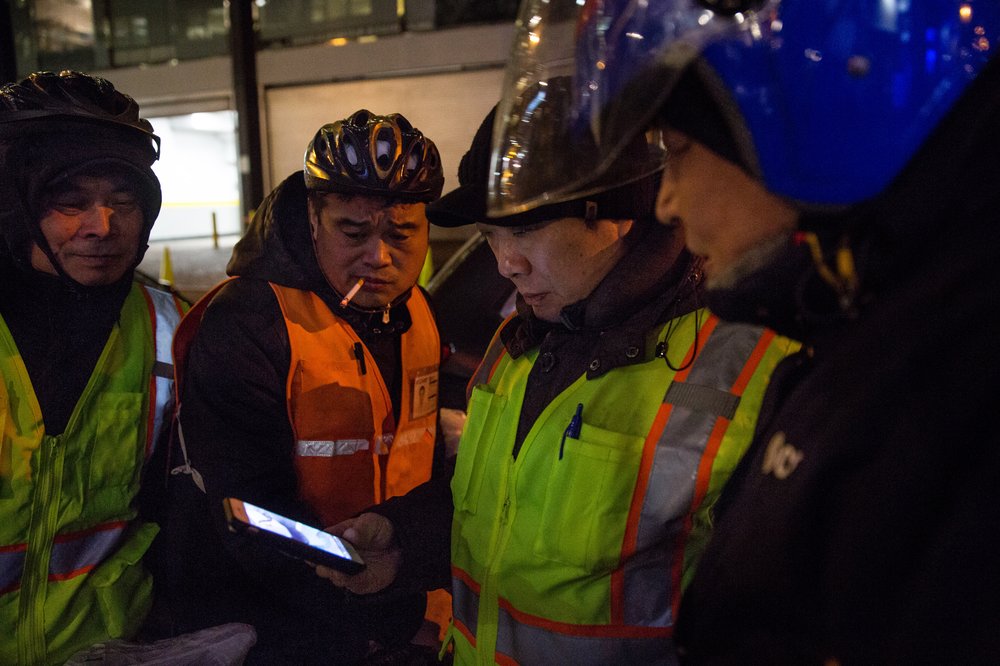 c7aa22c8b2018-01-18_heinsebikedigital-5-jpg.jpeg Delivery cyclists use WeChat to alert each other about where police seem to be confiscating their e-bikes. Here, a group of delivery cyclists in Midtown check a thread about a recent confiscation.<br/>