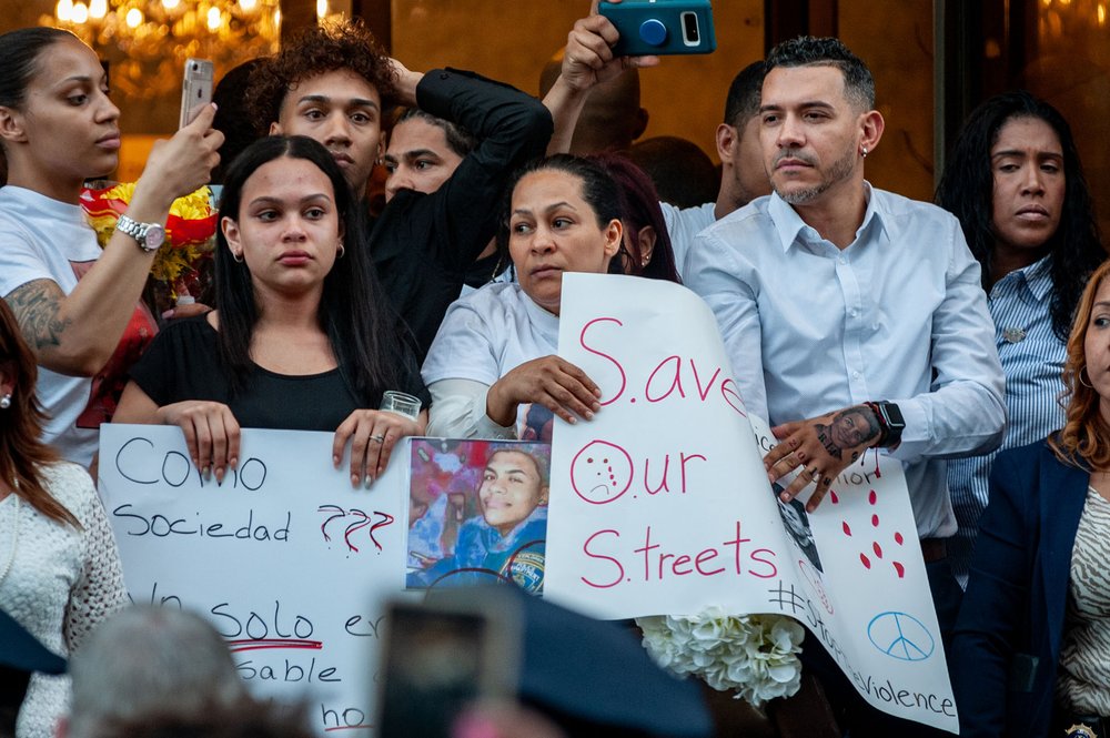 c97e17fd9_dsc3000-jpg.jpeg Lesandro Guzman-Feliz's family; his mother and father are holding the "Save Our Streets" sign<br>