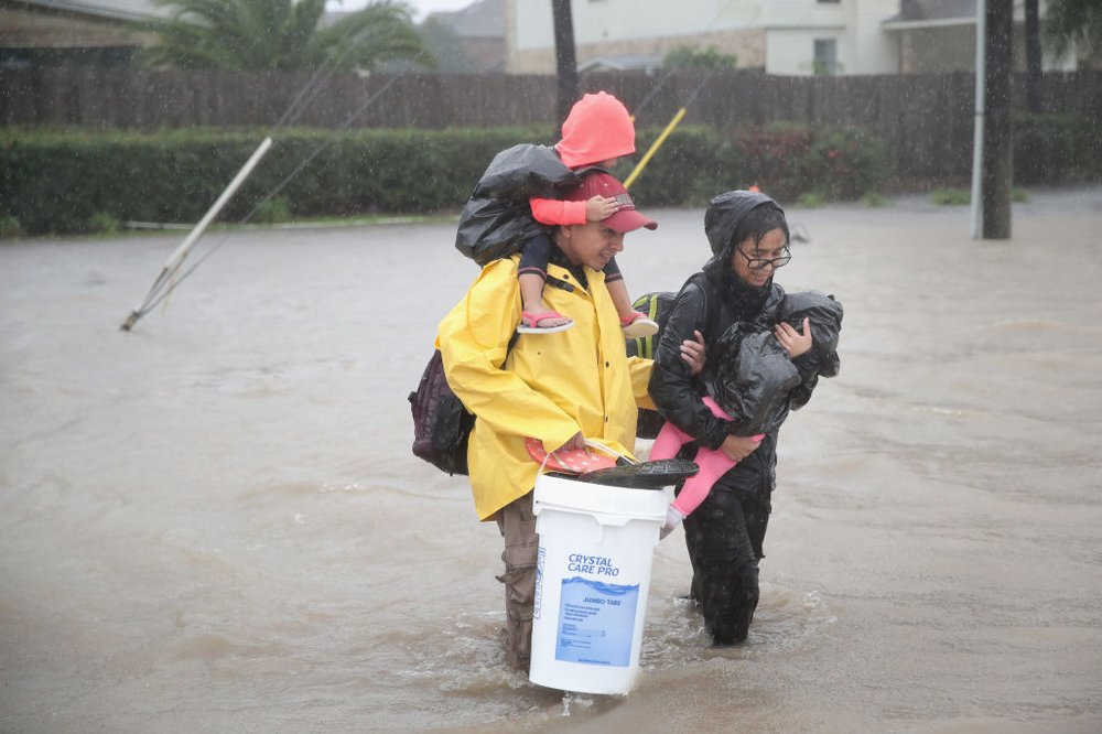 caad9c070gettyimages-840308500-jpg.jpeg People make their way out of a flooded neighborhood after it was inundated with rain water, remnants of Hurricane Harvey, on August 28, 2017 in Houston, Texas<br>