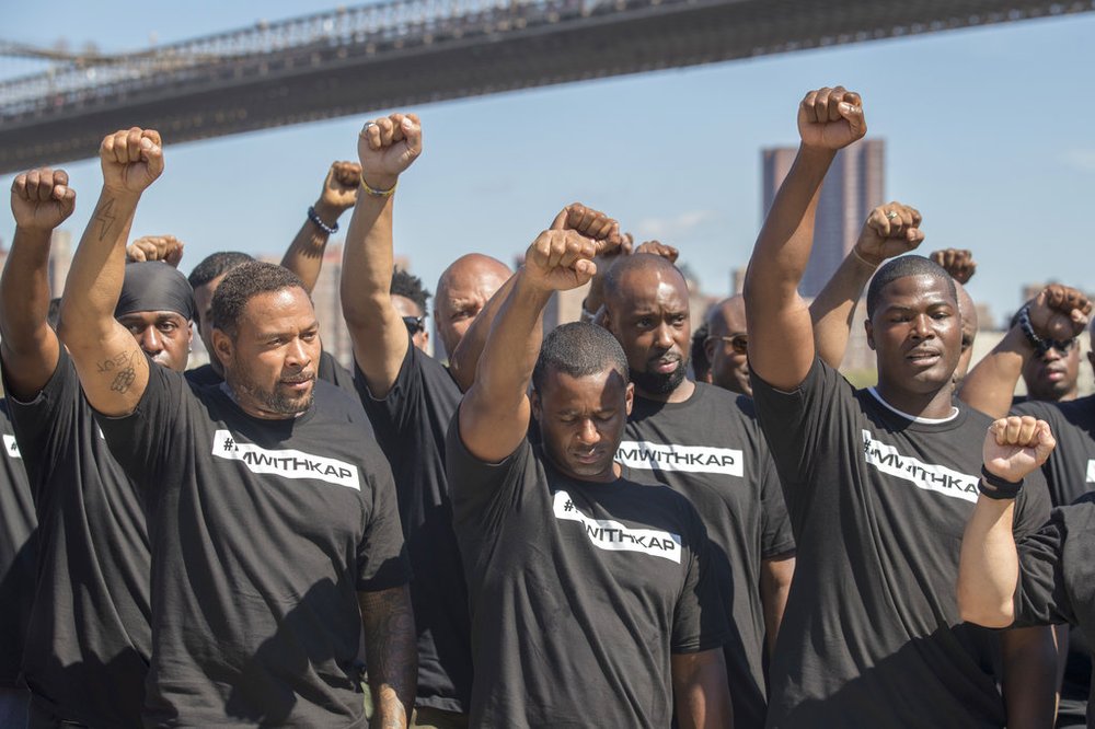 cb3a5053aap17231635932271-jpg.jpeg Members of law enforcement raise their fists during a rally to show support for Colin Kaepernick, Saturday, Aug. 19, 2017<br>