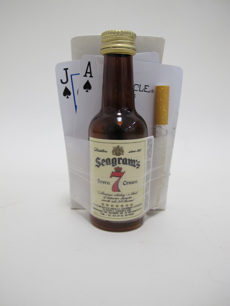cf9f4e7b617-vietnam-veterans-memorial-whisky-bottle-cards-cigarette-jpg.jpeg Deck of playing cards, mini bottle of whiskey, and cigarette with note left at the Vietnam Veterans Memorial in Washington, DC. Courtesy of the National and Memorial Parks, NPS<br/>