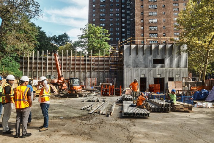 NYCHA is building a new pneumatic garbage system at the Polo Grounds development that will whoosh garbage and recycling at 60 mph in tubes from the apartment towers to this new terminal building for processing.