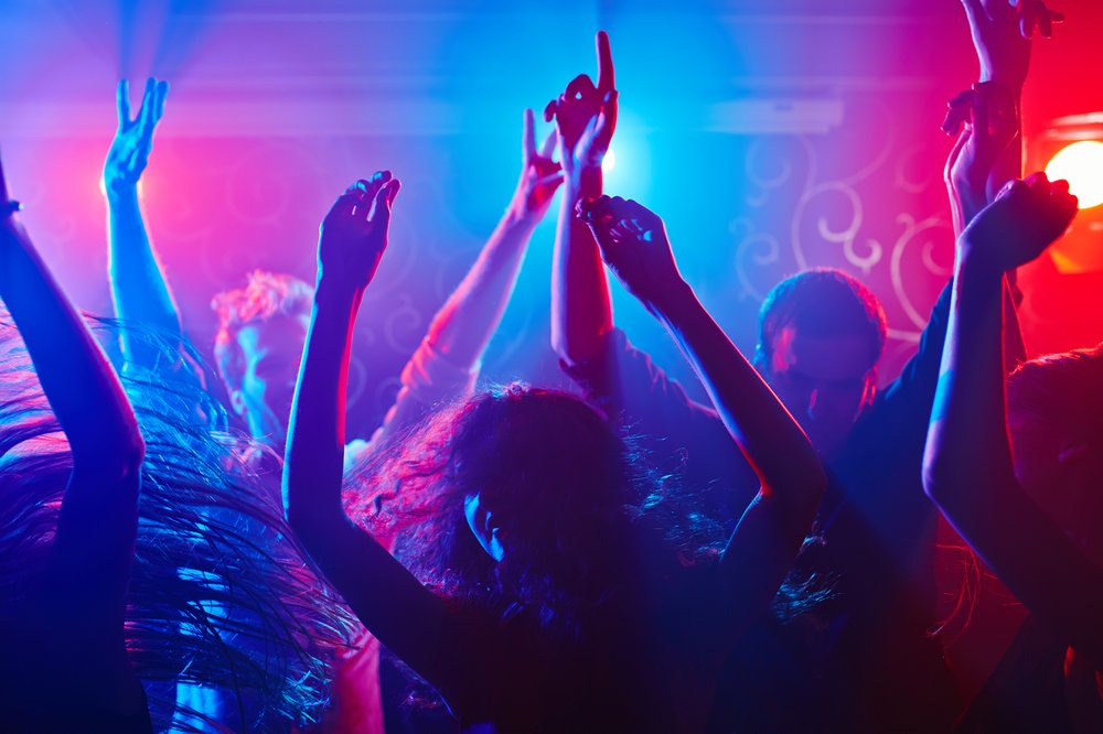 clubgoers with their hands up